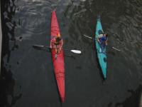 Two women paddling kayaks