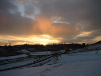 setting sun through snow flurries
